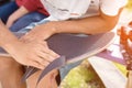 Boy cleans the trimmed edge the griptape on a skateboard Royalty Free Stock Photo