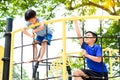 Boy climb on the rope fence