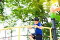 Boy climb on the rope fence