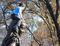 Boy Climbing on Alice in Wonderland in Central Park Royalty Free Stock Photo