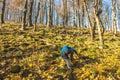 Boy is climbing on all four up to peak of stony hill Royalty Free Stock Photo