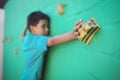 Boy climbing green wall Royalty Free Stock Photo