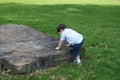 Boy Climbing Large Rock At Park Royalty Free Stock Photo