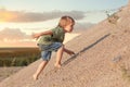 Boy Climbing On Mountain. Summer day and sand dune Royalty Free Stock Photo