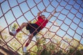 Boy climbing a net during obstacle course training Royalty Free Stock Photo