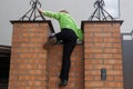 Boy climbing over brick fence Royalty Free Stock Photo