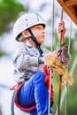 Boy climbing rope-ladder in adrenalin park Royalty Free Stock Photo