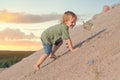 Boy Climbing On The Sand dune. Summer day Royalty Free Stock Photo