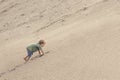 Boy Climbing On The Sand dune. Summer day Royalty Free Stock Photo