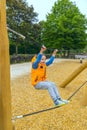 The boy climbing and sliding on slide in the playground. Happy children playing and having fun at playground Royalty Free Stock Photo