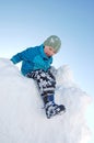 Boy climbing on snow pile
