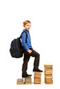 Boy climbing the stairs of books