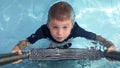 Boy climbing up pool ladder