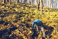 Boy is climbing up to peak of stony hill. Rubble field Royalty Free Stock Photo