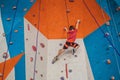 Boy at the climbing wall without a helmet, danger at the climbing wall