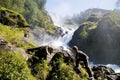 Boy climbing waterfall rocks Royalty Free Stock Photo