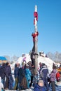 Boy climbing on a wooden pole for the prize, Slavonic folk festivities Shrovetide or Maslenitsa