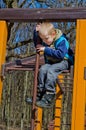 A boy climbs on playground