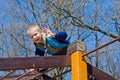 A boy climbs on playground