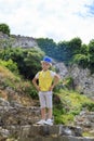 boy climbs the ruins of an ancient building