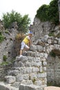 boy climbs the ruins of an ancient building