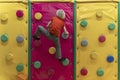 Boy climbs soft climbing wall. Child has fun in the childrens playroom. Soft room for games