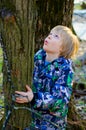 A boy climbs on a tree