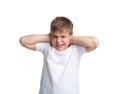 A boy close ears in a white t-shirt is isolated on a white background. Royalty Free Stock Photo