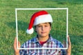 Boy in clownish cap of Santa Claus Royalty Free Stock Photo