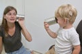 Boy with Cochlear Implants Playing Tin Can Phone Royalty Free Stock Photo