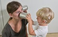 Boy with Cochlear Implants Playing Tin Can Phone Royalty Free Stock Photo