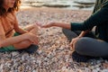 boy collects shells and pebbles in the sea on a sandy beach with his mother. Family having fun on the beach collecting shells Royalty Free Stock Photo