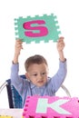 Boy with colorful letters in raised hands Royalty Free Stock Photo