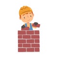 Boy Construction Worker Laying Bricks in Wall, Cute Little Builder Character Wearing Blue Overalls and Hard Hat Cartoon Royalty Free Stock Photo