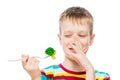 The boy with contempt looks at broccoli, portrait is isolated on white Royalty Free Stock Photo