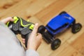 The boy is controling the blue toy car with a remote control. Child play with a toy car Royalty Free Stock Photo