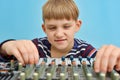 A boy controls a mixing console in a music studio Royalty Free Stock Photo