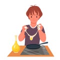 Boy cooking breakfast at home kitchen, cute child standing by table with electric stove Royalty Free Stock Photo