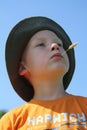 Boy with corn stalk in mouth