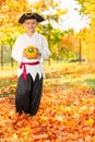 Boy in costume of pirate hold small pumpkin Royalty Free Stock Photo