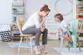 Boy with counselor in classroom Royalty Free Stock Photo