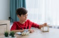 A boy counting money to put in saving box, saving money concept Royalty Free Stock Photo