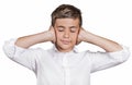 Boy covering ears with hands, doesn't want to hear loud noise, ignoring conversation Royalty Free Stock Photo