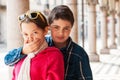 Child covers her mouth of her sister, portrait