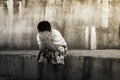 Asian boy crying alone at old wall ,vintage tone Royalty Free Stock Photo
