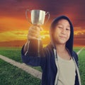 Boy with a cup and sun set at corner soccer filed