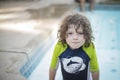 Boy with Curly Hair in Swimming Pool