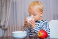 Boy cute baby eating breakfast. Baby nutrition. Eat healthy. Toddler having snack. Healthy nutrition. Drink milk. Child Royalty Free Stock Photo