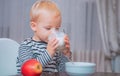 Boy cute baby eating breakfast. Baby nutrition. Eat healthy. Toddler having snack. Healthy nutrition. Drink milk. Child Royalty Free Stock Photo