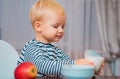 Boy cute baby eating breakfast. Baby nutrition. Eat healthy. Toddler having snack. Drink milk. Child hold glass of milk Royalty Free Stock Photo